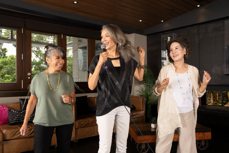 Group of senior women dancing and singing.